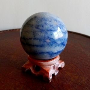 Blue calcite crystal sphere. 298g. Approx. 2.1" width. 7.5" circumference.